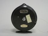 a black reel with a yellow tag on it