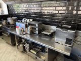 stainless steel counter top in a commercial kitchen with appliances on it