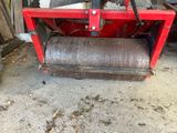 a red machine that is sitting on the ground