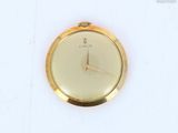 a gold watch with a white face on a white surface