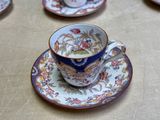 a cup and saucer sitting on a table