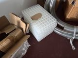 a pile of boxes and a box with a piece of cardboard on it