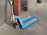 a blue hand truck that is parked in a warehouse