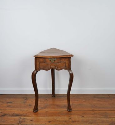 an old wooden table with a drawer on top of it
