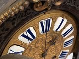 a close up of a clock that is on the wall