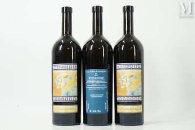 three bottles of wine sitting next to each other on a white surface