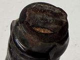 a close up of a bottle of wine with a rusted cap