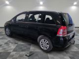 a picture of a black minivan parked in a garage