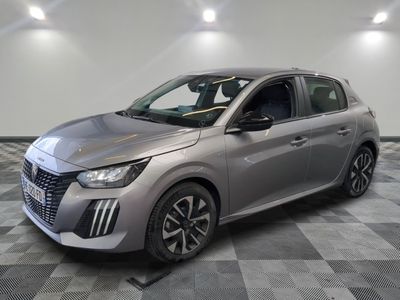 a silver car is parked on a checkered floor in a showroom