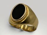 a gold ring with a black stone in the center