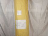 a yellow bag that is sitting on top of a white sheet