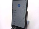a broken cell phone sitting on a stand on a table
