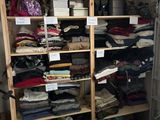a closet full of clothes and other items in the room