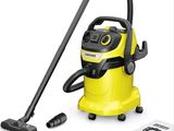un aspirateur jaune muni d'un tuyau noir et d'autres articles de ménage