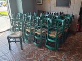 tables and chairs in a room with a brick floor and a large window