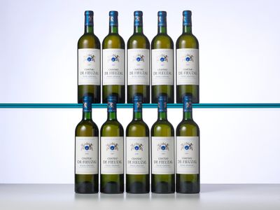 six bottles of white wine sit on a shelf in front of a glass shelf