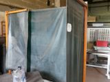 a small room with a large screen and a water bottle on the table
