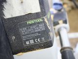 a close up of a black and white machine with a yellow sticker on it
