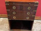 une vieille commode surmontée de ferrures en laiton