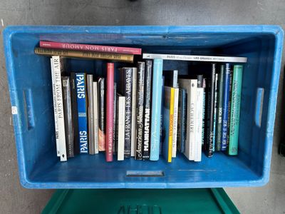 a blue box with books in it on the floor