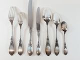 a lot of spoons and forks on the table