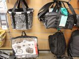 many bags hanging on the wall in the store