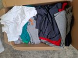 a box full of clothes that is sitting on the floor