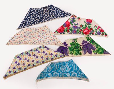 several pieces of cloth are arranged in a row on a white surface