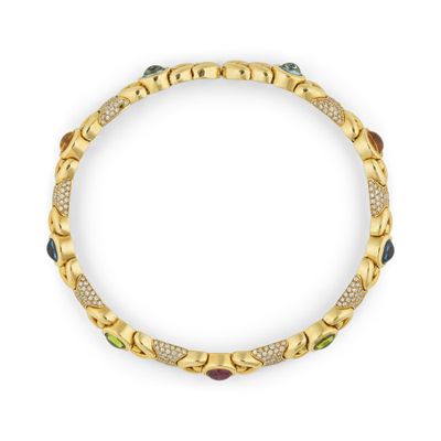 un bracelet en or orné de pierres multicolores et de diamants