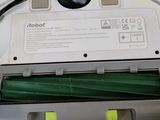 someone is removing the bottom of a vacuum cleaner with a green cloth