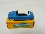 a blue toy car sitting on top of a yellow box