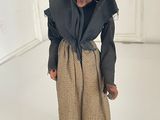 figurine of an old woman wearing a black robe and a scarf