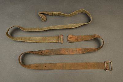 two belts and a belt on a table with a piece of cloth