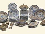 a lot of blue and white plates and bowls on the table