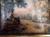 a picture of a painting of a forest scene in a gold frame