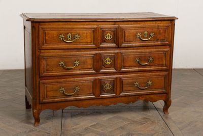 an antique chest of drawers with a marble top and brass handles
