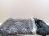 a plastic bag on top of a mattress on the floor