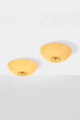 a pair of yellow earrings sitting on top of a white surface