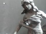 a statue of a woman holding a tennis racquet