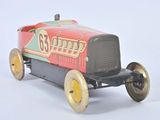 a red toy car with yellow wheels on a white surface