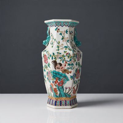 a vase that is sitting on a table in front of a gray wall