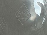 a close up of a glass vase with a logo on it