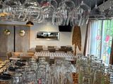 many glasses hanging from the ceiling in a restaurant