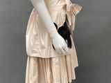 an image of a mannequin wearing a beige dress and black shoes