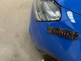 a close up of a blue car with a sticker on it