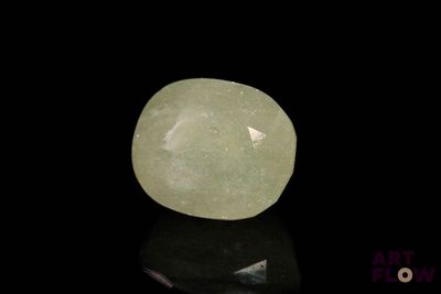 an image of a green jade stone on a black surface
