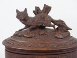 a wooden box with a dog and a bird on it