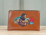 an image of a brown purse with a picture of a man holding a tennis racquet