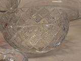 a glass bowl and a bowl with a spoon on a table