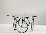 an image of a glass table with wheels on it